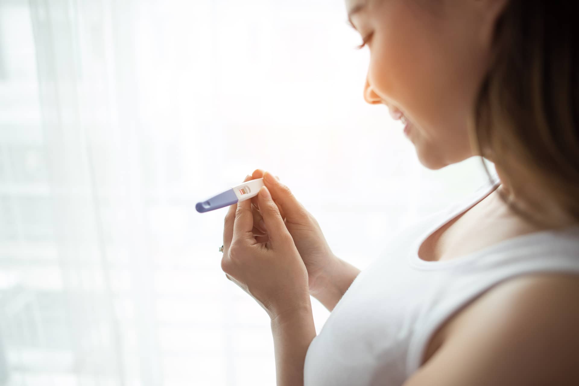 young-woman-hand-holding-pregnancy-test